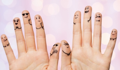 fingers with smiles drawn on them