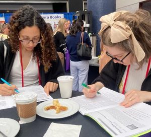 2 teachers choosing workshops from the booklet