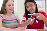 two girls learning chemistry